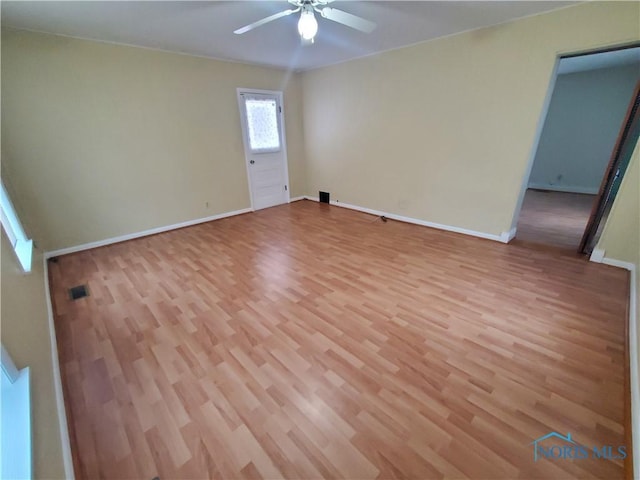 unfurnished room with ceiling fan and light hardwood / wood-style floors