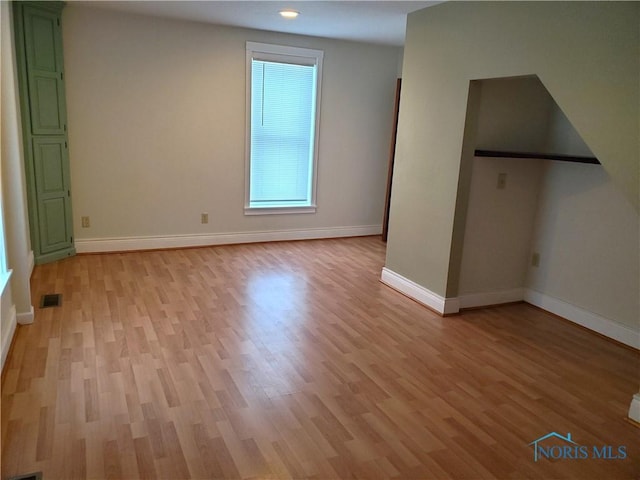 spare room featuring light hardwood / wood-style floors