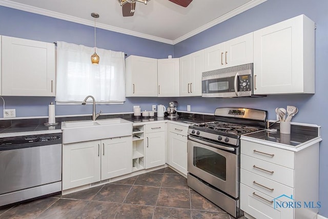 kitchen featuring decorative light fixtures, sink, stainless steel appliances, ornamental molding, and white cabinets