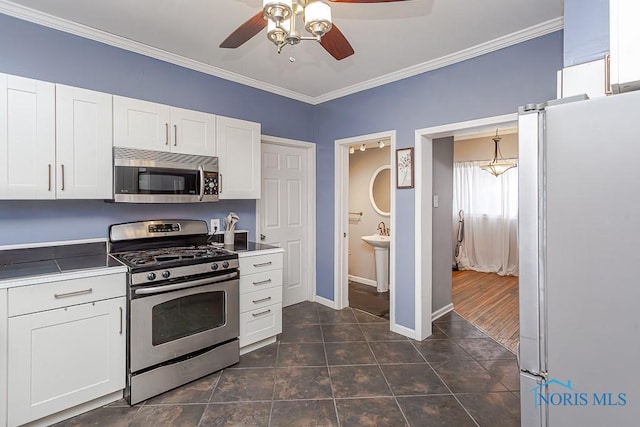 kitchen featuring crown molding, white cabinets, and stainless steel appliances