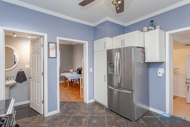 kitchen featuring ceiling fan, white cabinets, stainless steel fridge, and ornamental molding