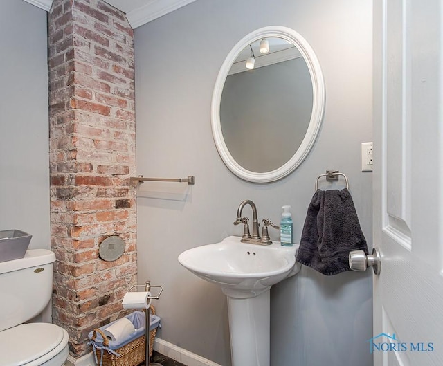 bathroom with toilet and ornamental molding