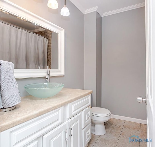 bathroom featuring toilet, vanity, tile patterned flooring, and crown molding