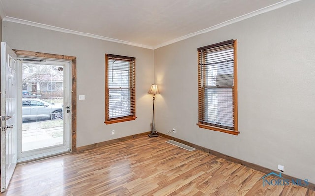 doorway to outside featuring light wood-type flooring and ornamental molding