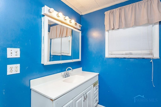 bathroom with vanity and ornamental molding