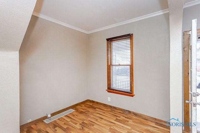 unfurnished room with light hardwood / wood-style floors and ornamental molding