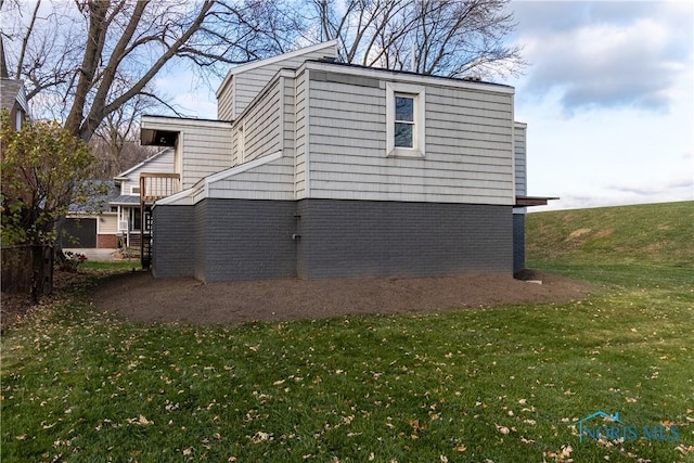 view of side of home featuring a yard