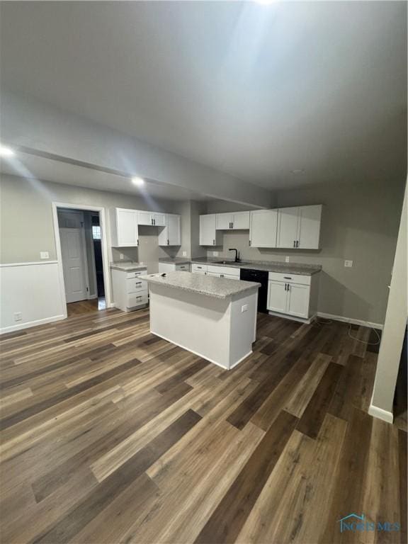 kitchen featuring white cabinetry, a center island, sink, and black dishwasher