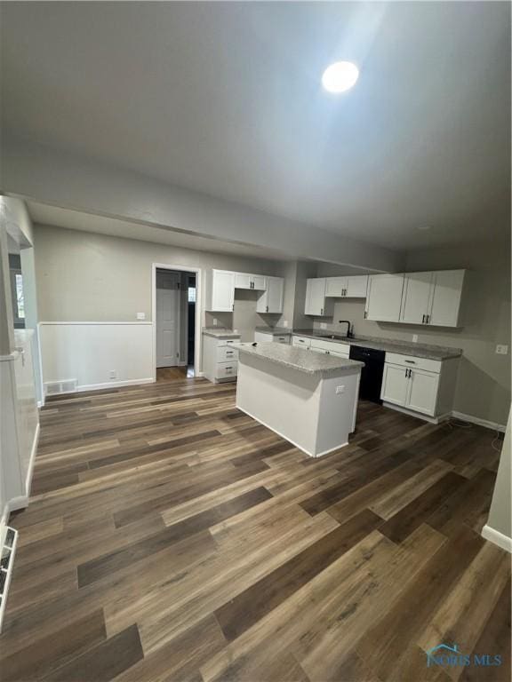 kitchen with a center island, white cabinets, and dark hardwood / wood-style floors