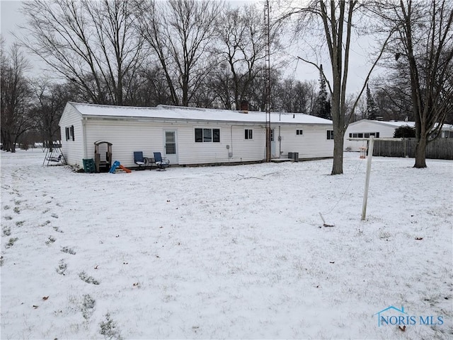 snow covered property with cooling unit