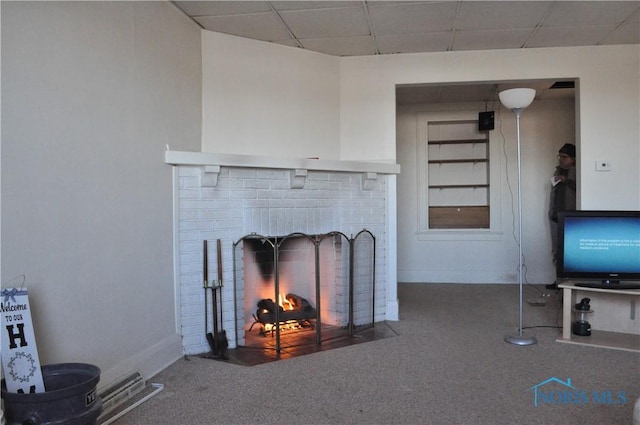 unfurnished living room with a paneled ceiling and carpet floors