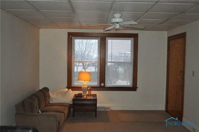 living area with carpet flooring and ceiling fan