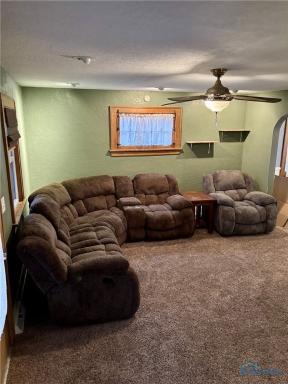 living room featuring carpet and ceiling fan