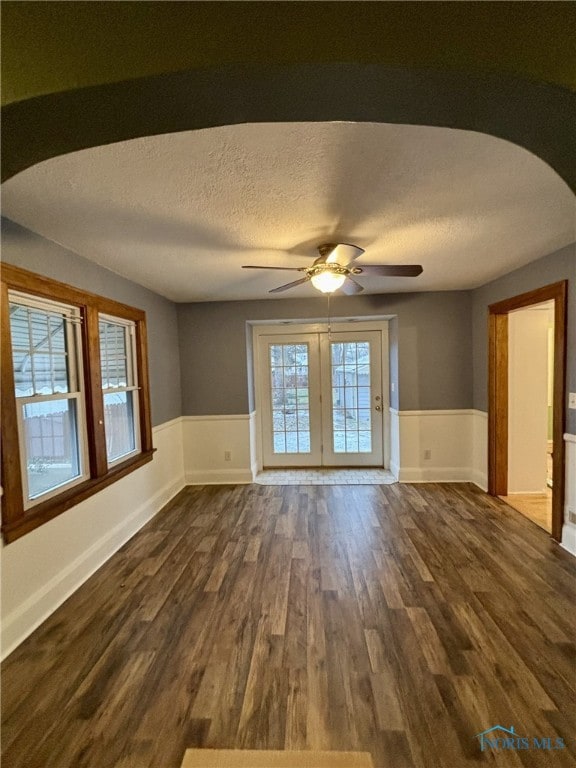 spare room featuring a textured ceiling, ceiling fan, and dark hardwood / wood-style floors