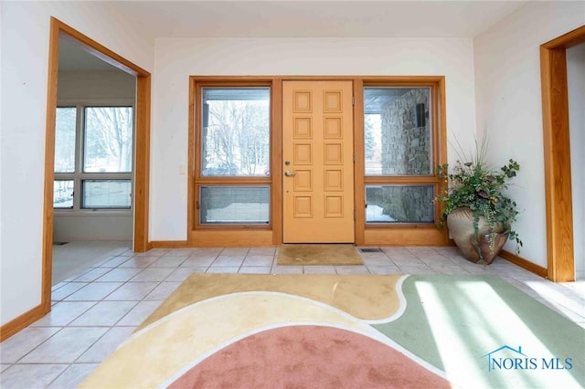 foyer entrance featuring a healthy amount of sunlight and light tile patterned floors