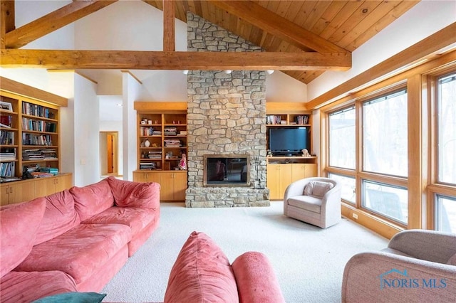 living room featuring built in shelves, high vaulted ceiling, and a stone fireplace