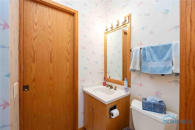 bathroom featuring vanity and toilet