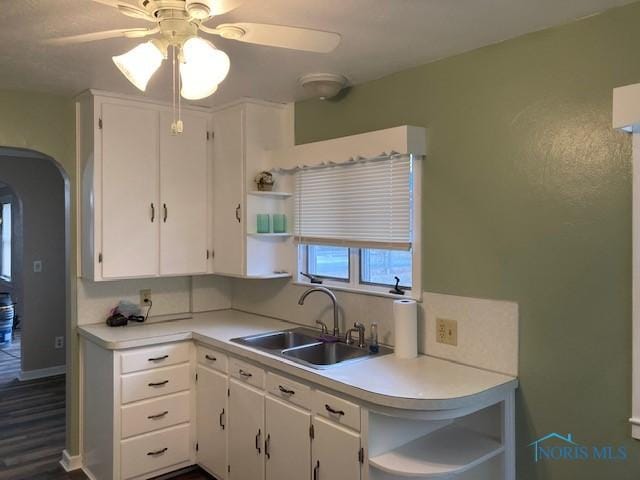 kitchen featuring white cabinets, hardwood / wood-style flooring, ceiling fan, and sink