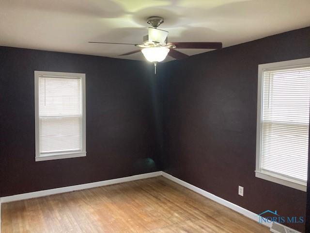 spare room with ceiling fan and hardwood / wood-style floors