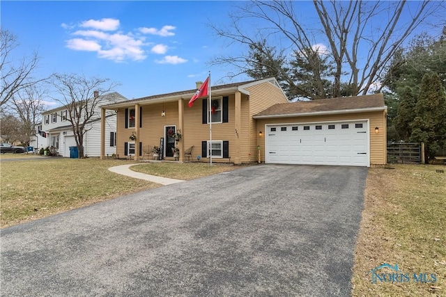 view of front facade with a garage and a front lawn