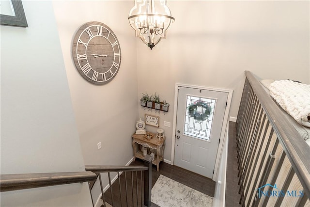 foyer with wood-type flooring and a chandelier