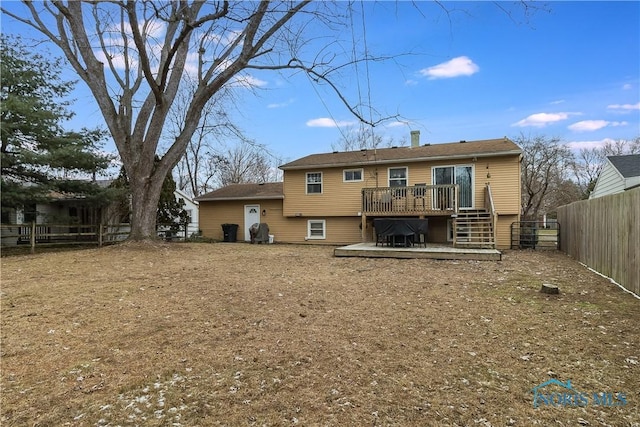 rear view of property featuring a wooden deck