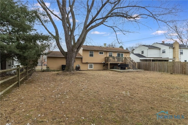 back of house with a deck