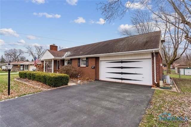 single story home with a front yard and a garage