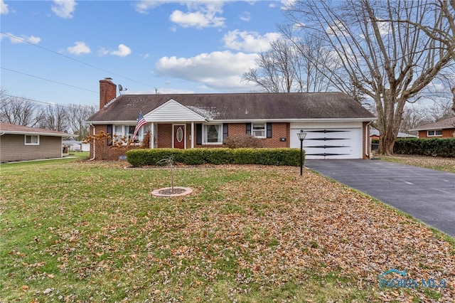 single story home featuring a garage and a front lawn