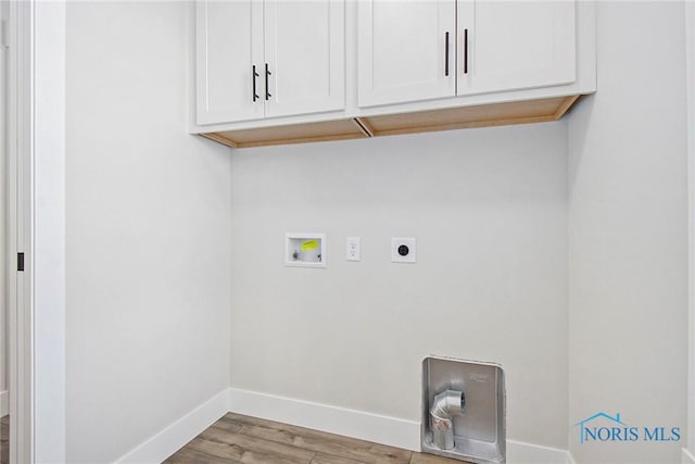 laundry area with cabinets, washer hookup, light hardwood / wood-style floors, and hookup for an electric dryer