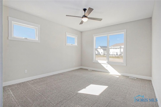 carpeted empty room featuring ceiling fan