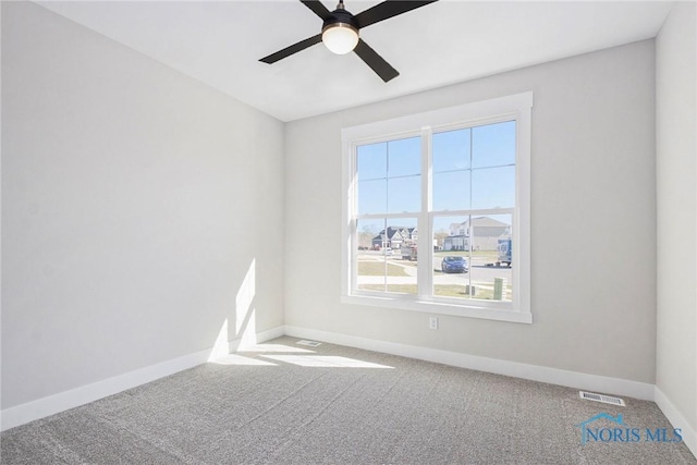 spare room with carpet and ceiling fan