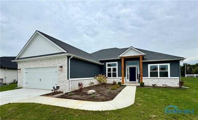 view of front of house with a garage and a front lawn