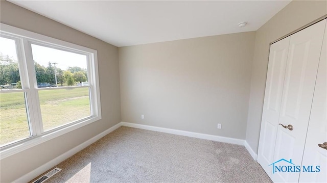 unfurnished bedroom featuring a closet and carpet floors