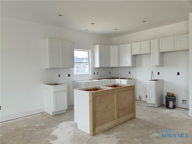 kitchen with white cabinetry and a center island