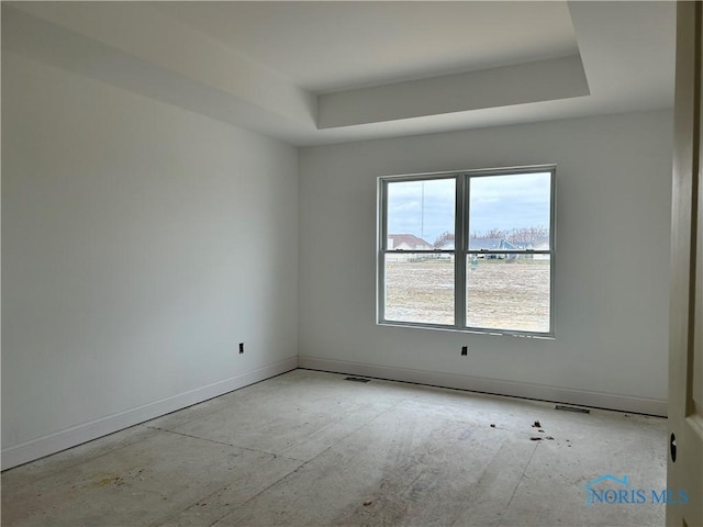 empty room with a raised ceiling