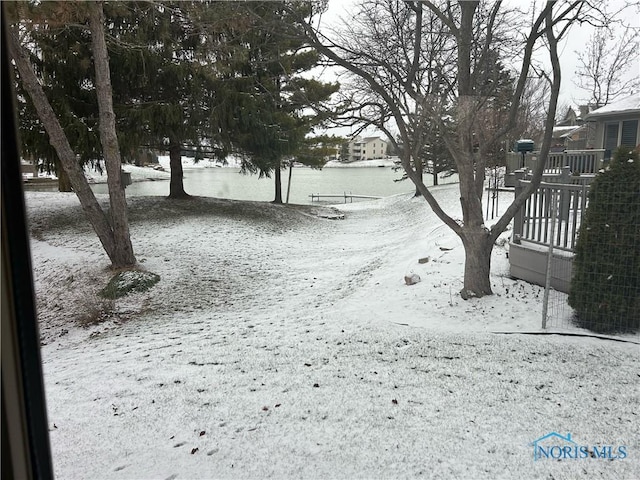 yard layered in snow featuring a deck