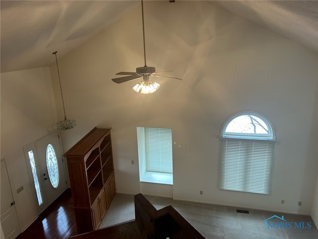 entrance foyer featuring ceiling fan, a textured ceiling, and high vaulted ceiling