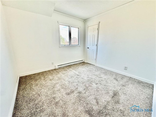 empty room with carpet flooring, ornamental molding, and baseboard heating