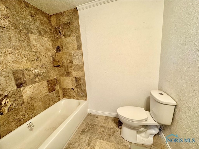 bathroom featuring a textured ceiling, toilet, and shower / bathtub combination