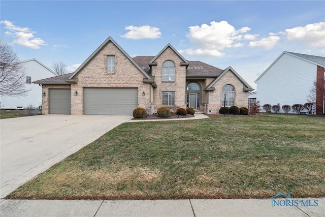 view of front of property with a garage and a front lawn