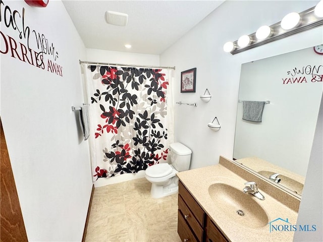 bathroom with vanity, toilet, and walk in shower