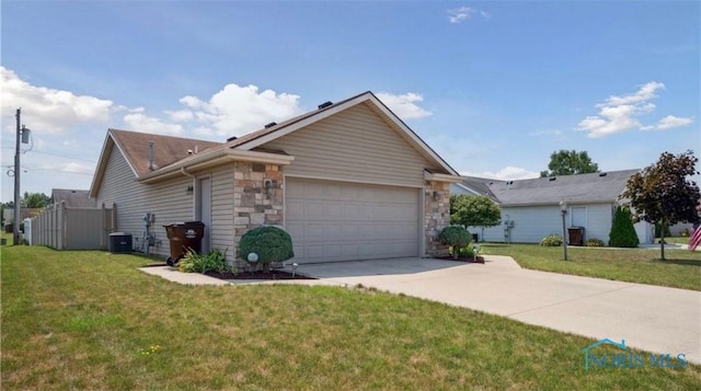 view of front facade featuring central AC unit, a garage, and a front yard