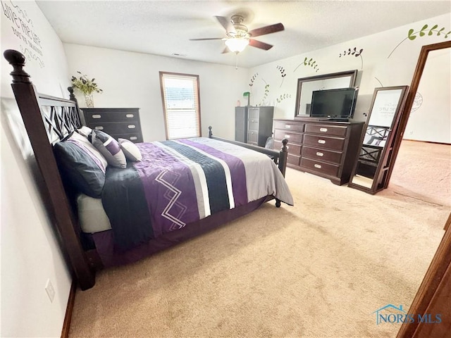 bedroom with ceiling fan and carpet floors