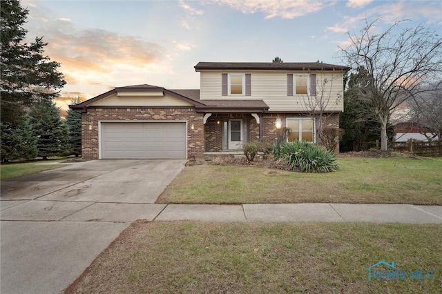 front of property with a yard and a garage