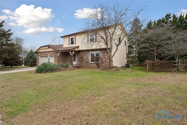 view of property featuring central air condition unit, a front yard, and a garage