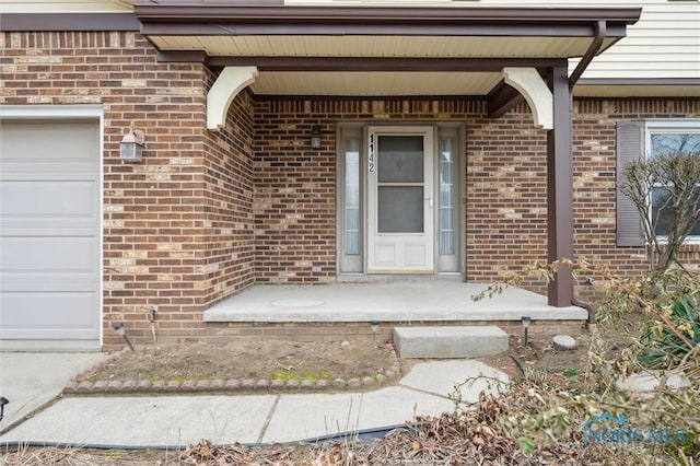 view of exterior entry with a garage