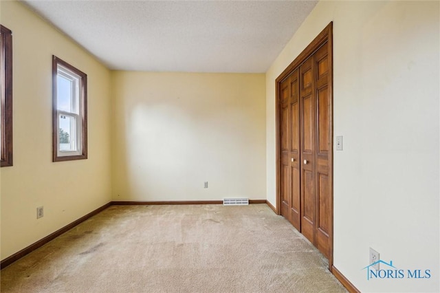 unfurnished bedroom with light carpet