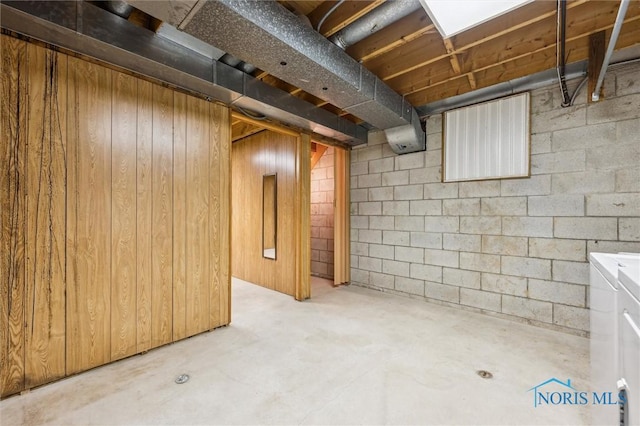 basement featuring wood walls