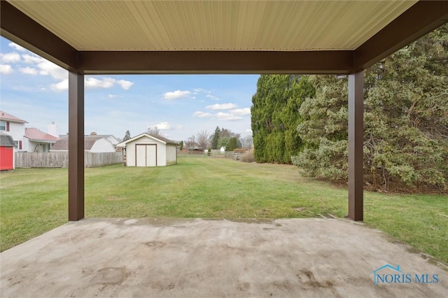 view of yard with a patio and a storage unit